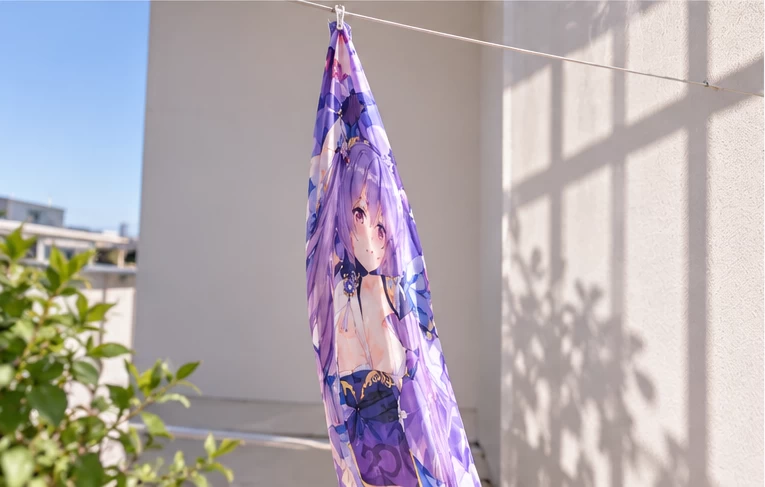 Wet dakimakura cover hanging from a single corner