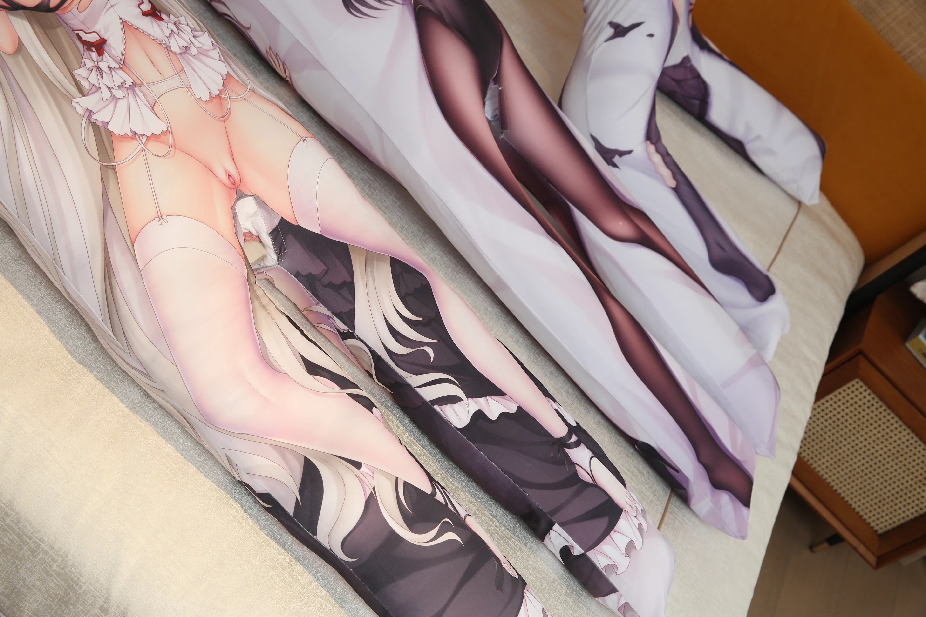 Close-up real photo of custom printed body pillows and their lower sections.